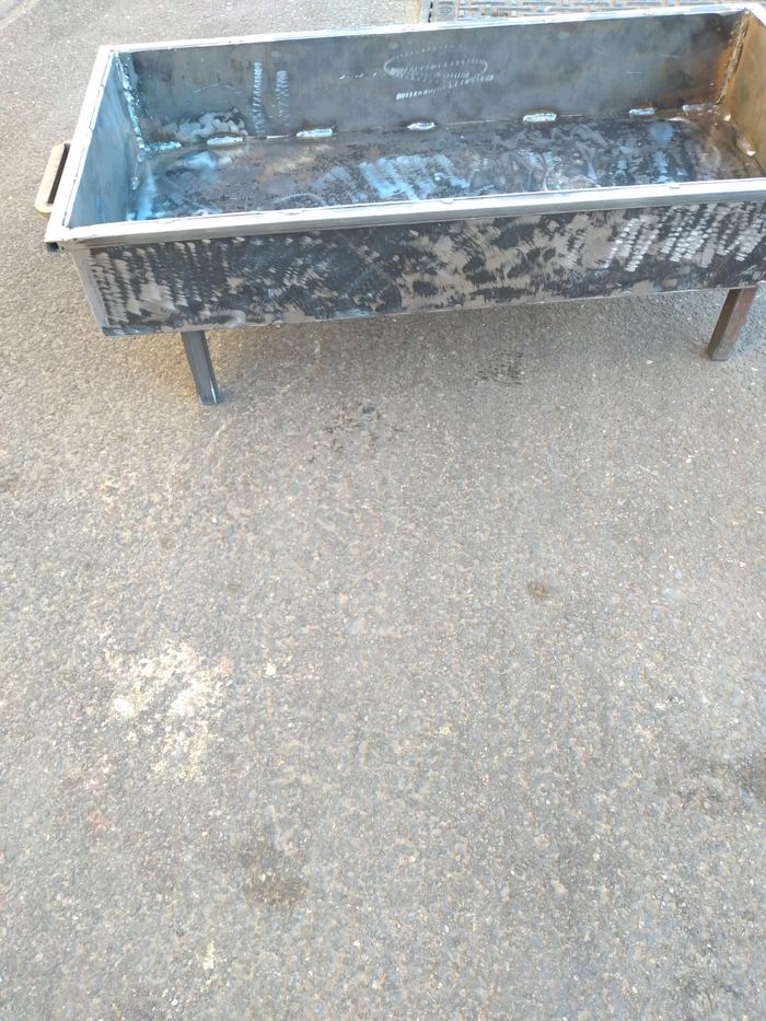 Custom-welded steel planter box with a brushed finish