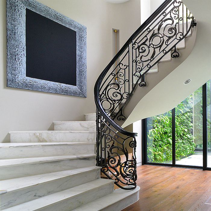 Ornate wrought iron staircase balustrade in a modern home